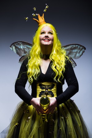 Amy in her Bumblina Queen Bee outfit holding a yellow ball. 